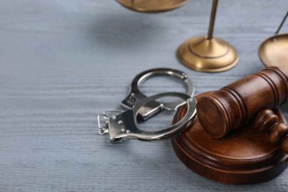 Gavel, Handcuffs And Scales Of Justice On Grey Wooden Table, Spa