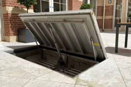 Hidden Passages for Heavy Things: Why Buildings Use Floor Hatches