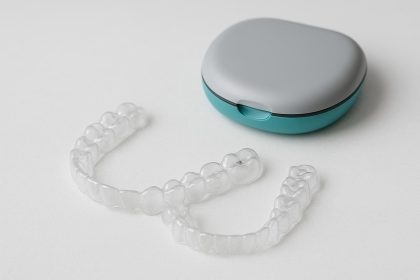 Clear Invisalign aligners on a dental tray, highlighting orthodontic treatment options in Surrey