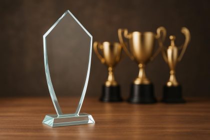 Clear glass award trophy displayed on a desk, symbolizing modern business recognition preferences