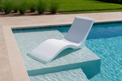 Modern ledge lounger chair positioned on a pool ledge with water and luxury outdoor setting