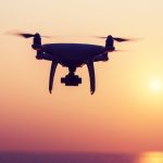 Silhouette,Of,Flying,Drone,Which,Taking,Photo,Over,Sunrise,Sea
