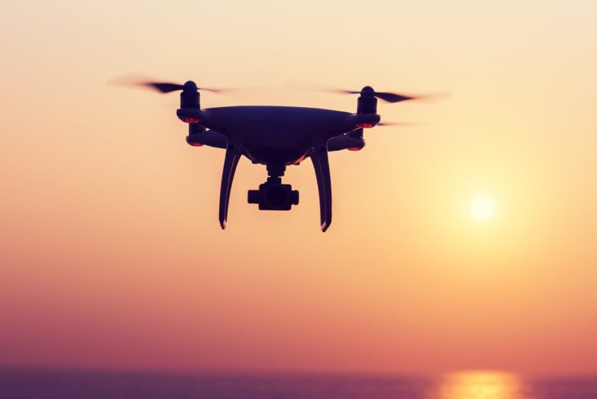 Silhouette,Of,Flying,Drone,Which,Taking,Photo,Over,Sunrise,Sea
