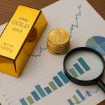Gold IRA reviews comparison with gold bars, retirement planning documents, and financial charts