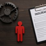 Broken bone x-ray with insurance documents illustrating injury and insurance claim process