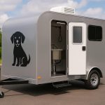Modern mobile dog grooming trailer parked outdoors, showcasing professional pet grooming features