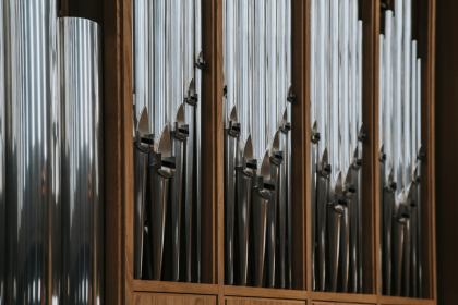 Restored century-old pipe organ inside historic building, highlighting preservation efforts