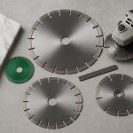 Assorted marble cutting blades arranged for professional use on a construction workbench