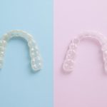 Close-up of clear invisible aligners showing updated design and improved dental technology